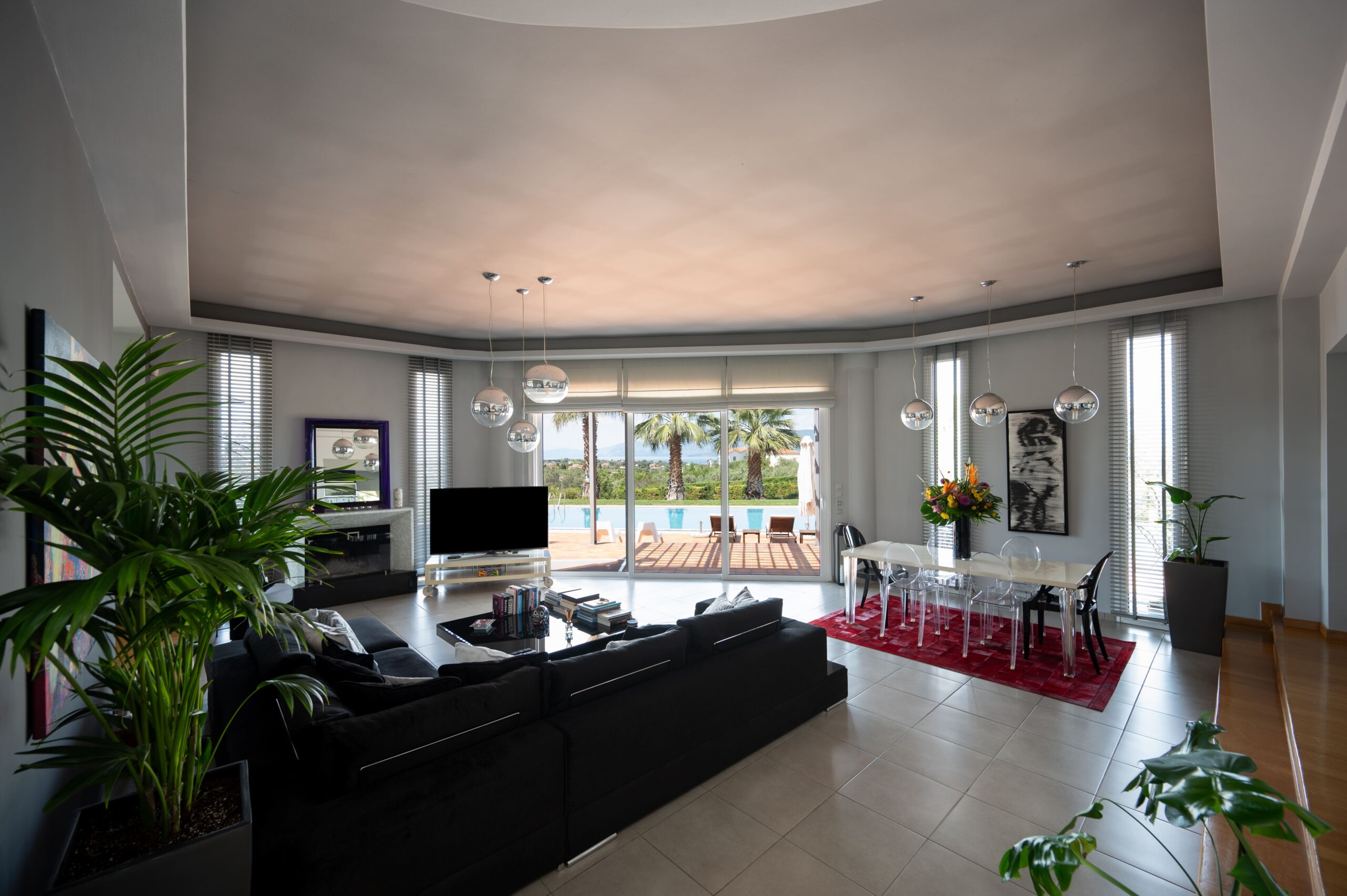 Modern living room with TV, fireplace, and patio access